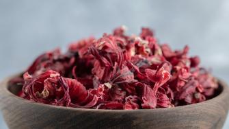Dry hibiscus tea in wooden bowl. High quality photo