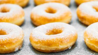 Sweet dessert with many donut on top with sugar icing - Unhealthy food style